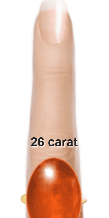 Orangey Red 26 carat cabochon-cut Sunstone on a ring and finger.