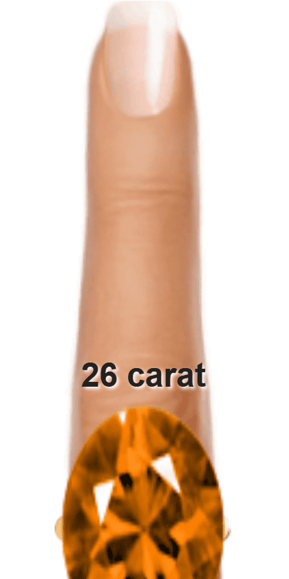 Orange 26 carat oval-cut Andesine on a ring and finger.